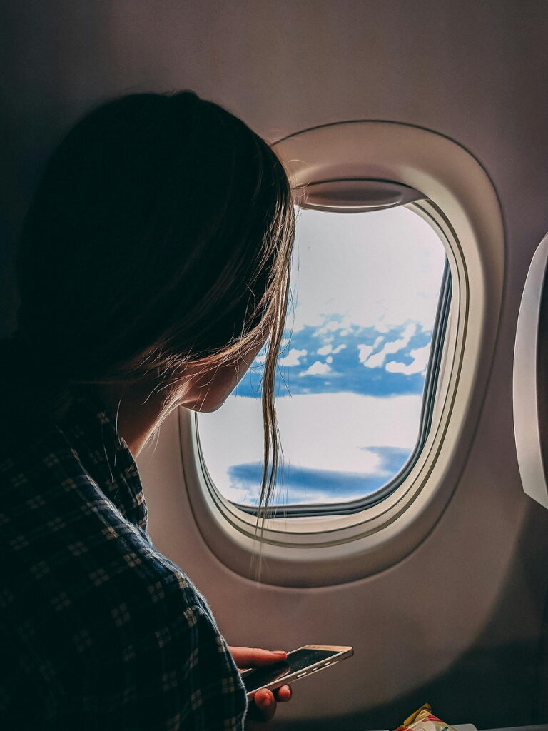 Woman looking out the plane window